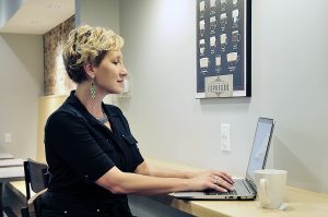 Woman at computer, growing your business, help get organized, personal assistant service, companion visits